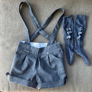 Gray suspendered gray wool Bonpoint shorts w black bows at sides.